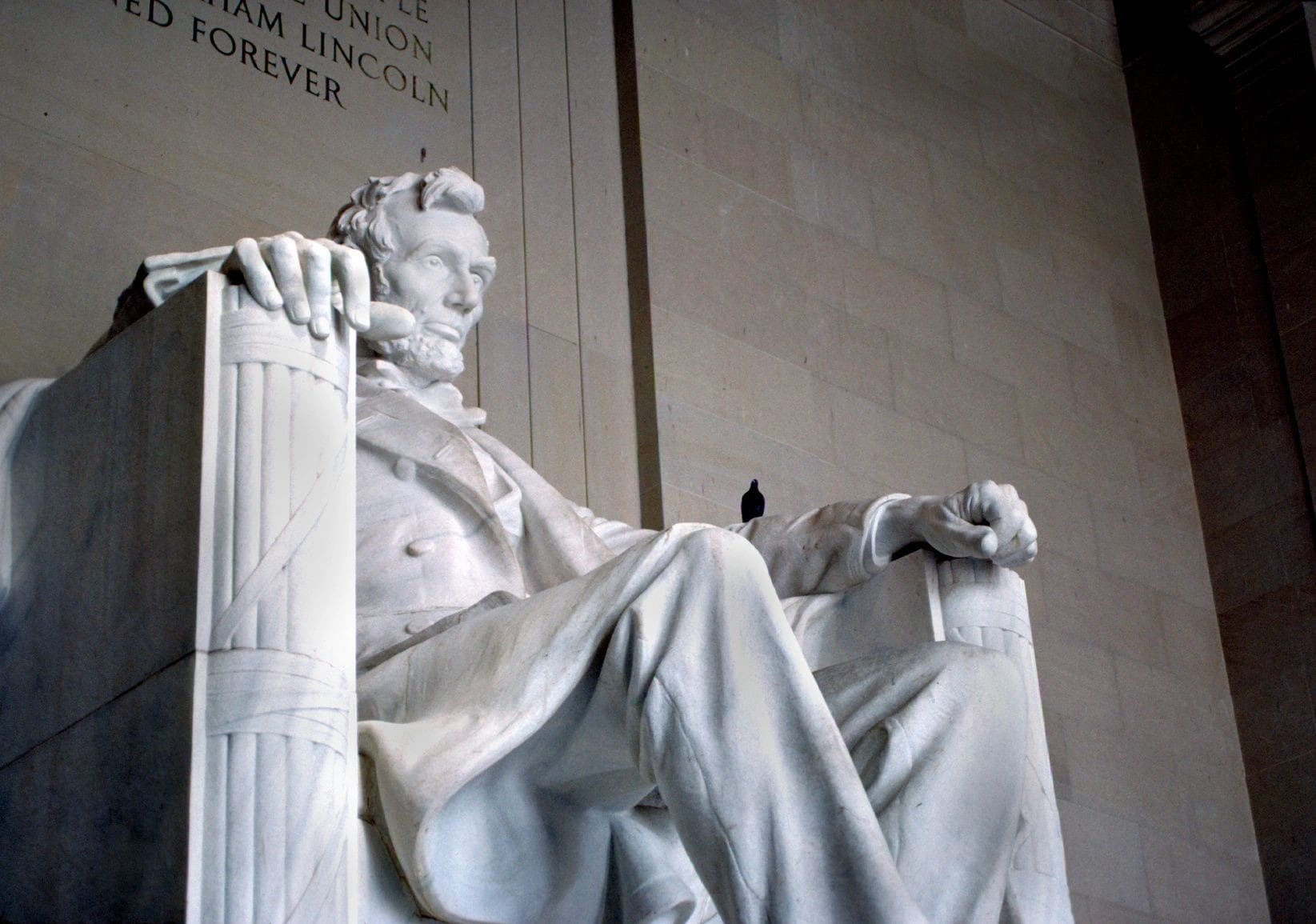 A statue of abraham lincoln sitting in the middle of a chair.