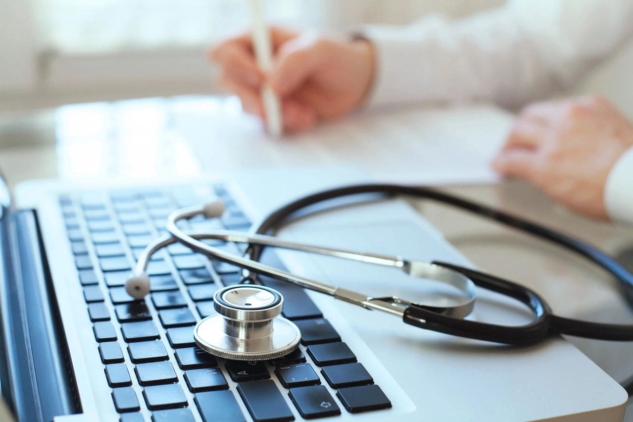 A stethoscope sitting on top of a keyboard.