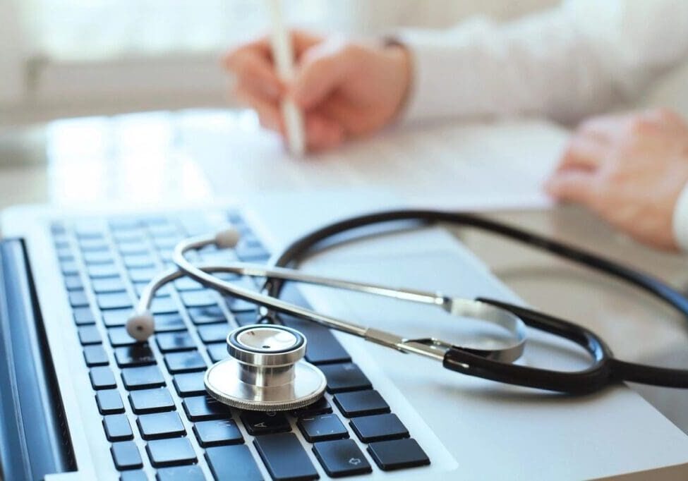 A stethoscope sitting on top of a keyboard.